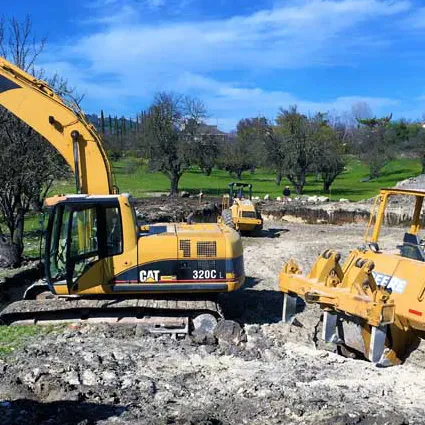 CAT Excavator and other Earth Working Machines preparing a home building site in California