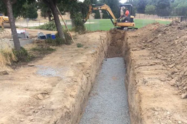 Construction crew digging a french drain in Paso Robles Califonia Construction crew digging a french drain in Paso Robles Califonia