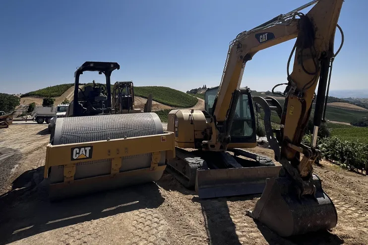 Wilber Construction CAT Earthworking equipment and excavator in vinyard in California Wilber Construction CAT Earth working equipment and excavator in vineyard in California