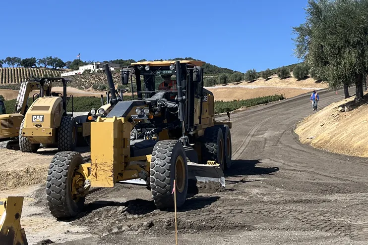 Wilber Construction leveling road with construction equipment in a vineyard in California Wilber Construction leveling road with construction equipment in a vineyard in California